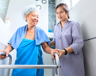 caregiver assisting to her patient to walk